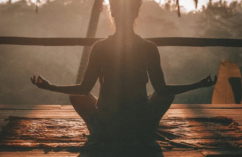 Woman meditating in morning light