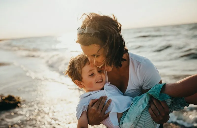 Mother hugging her child at the beach